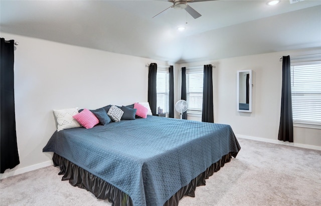 bedroom featuring multiple windows, carpet floors, baseboards, and vaulted ceiling