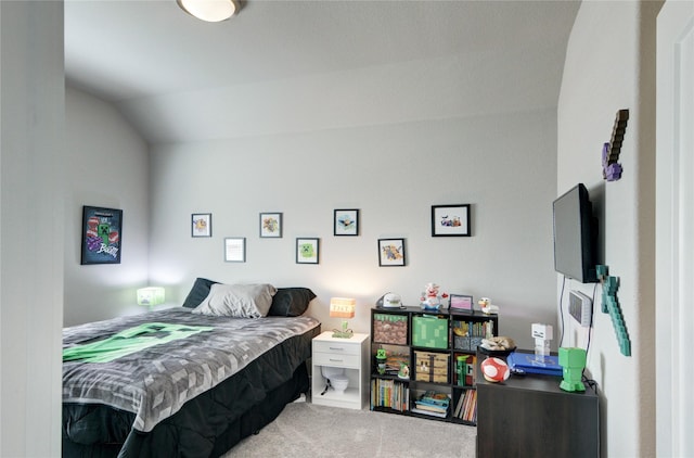 bedroom featuring lofted ceiling and carpet