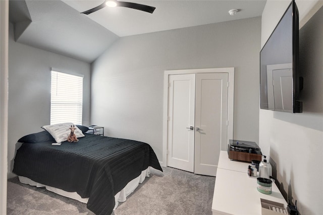 carpeted bedroom featuring a ceiling fan and vaulted ceiling