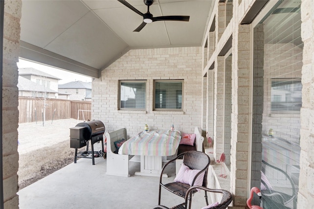 view of patio with ceiling fan, fence, and grilling area