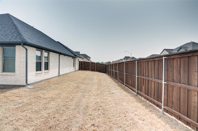 view of yard with a fenced backyard