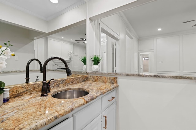 bathroom featuring crown molding, recessed lighting, a decorative wall, vanity, and a ceiling fan
