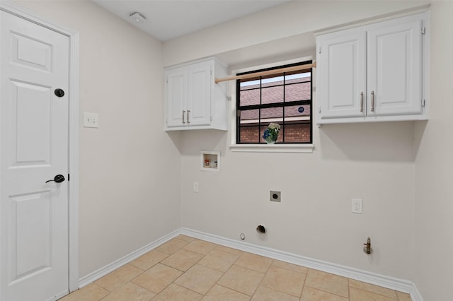 clothes washing area with hookup for a washing machine, cabinet space, hookup for an electric dryer, gas dryer hookup, and baseboards