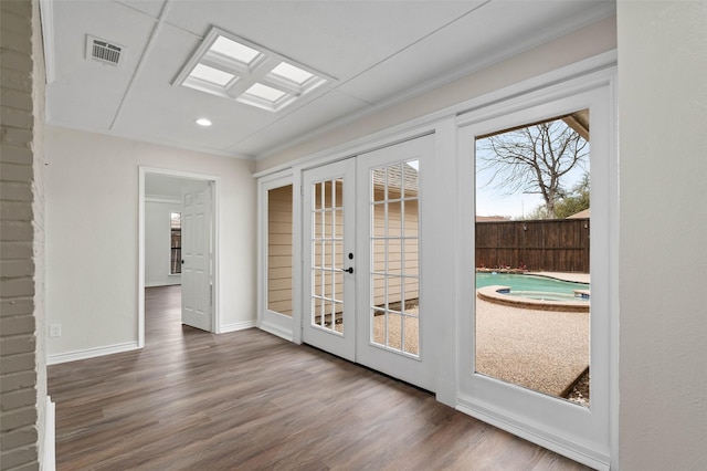 doorway with recessed lighting, visible vents, baseboards, french doors, and wood finished floors