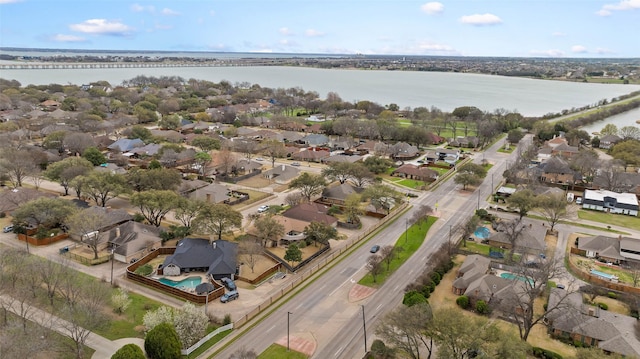 drone / aerial view with a water view and a residential view