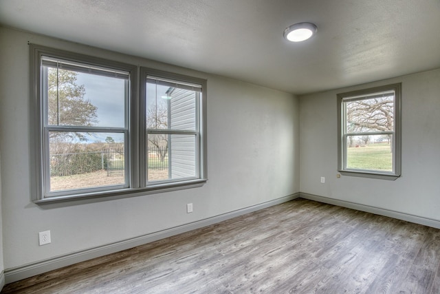 237 Runaway Bay Dr, Runaway Bay, TX 76426 - unfurnished bedroom with wood finished floors, a closet, visible vents, and baseboards