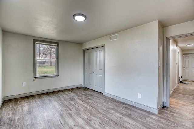 237 Runaway Bay Dr, Runaway Bay, TX 76426 - unfurnished bedroom with wood finished floors, a closet, visible vents, and baseboards