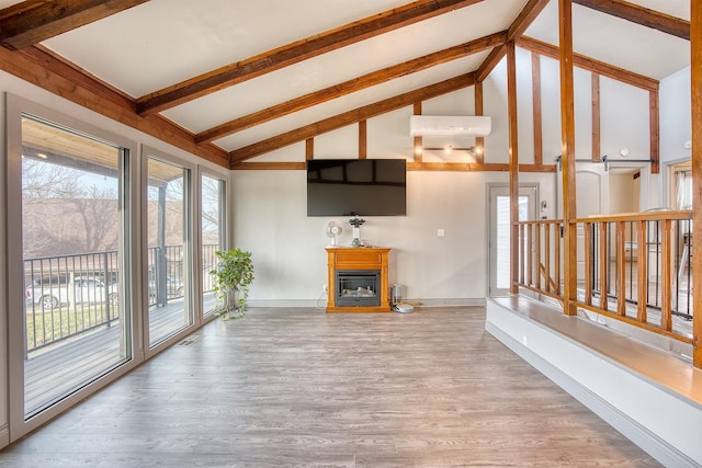 237 Runaway Bay Dr, Runaway Bay, TX 76426 - unfurnished living room with wood finished floors, beamed ceiling, a fireplace, baseboards, and high vaulted ceiling