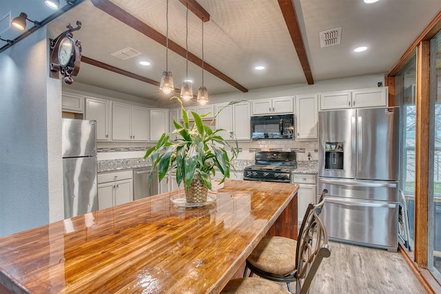 237 Runaway Bay Dr, Runaway Bay, TX 76426 - kitchen featuring stainless steel appliances, beamed ceiling, light wood finished floors, a sink, and a center island