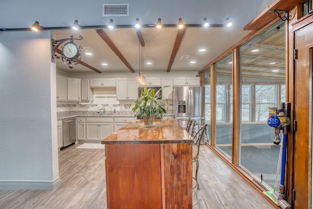 237 Runaway Bay Dr, Runaway Bay, TX 76426 - kitchen featuring a sink, light wood-style floors, black appliances, beam ceiling, and backsplash