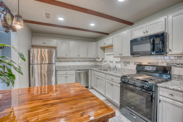 237 Runaway Bay Dr, Runaway Bay, TX 76426 - kitchen with tasteful backsplash, visible vents, black appliances, beam ceiling, and butcher block counters