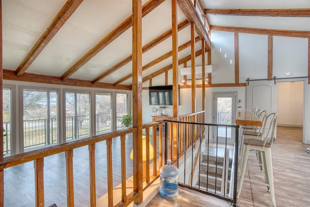 237 Runaway Bay Dr, Runaway Bay, TX 76426 - spare room with ceiling fan, a wall unit AC, vaulted ceiling with beams, and light wood-style floors