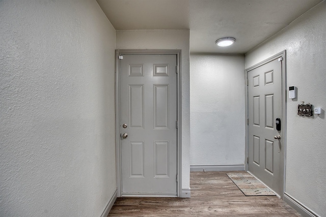 237 Runaway Bay Dr, Runaway Bay, TX 76426 - doorway to outside featuring wood finished floors, a textured wall, and baseboards