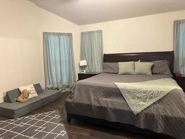 1615 Summerfield Dr, Allen, TX 75002 - bedroom featuring lofted ceiling and wood finished floors