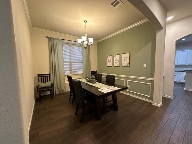 1615 Summerfield Dr, Allen, TX 75002 - dining area with arched walkways, a chandelier, ornamental molding, dark wood-style floors, and baseboards