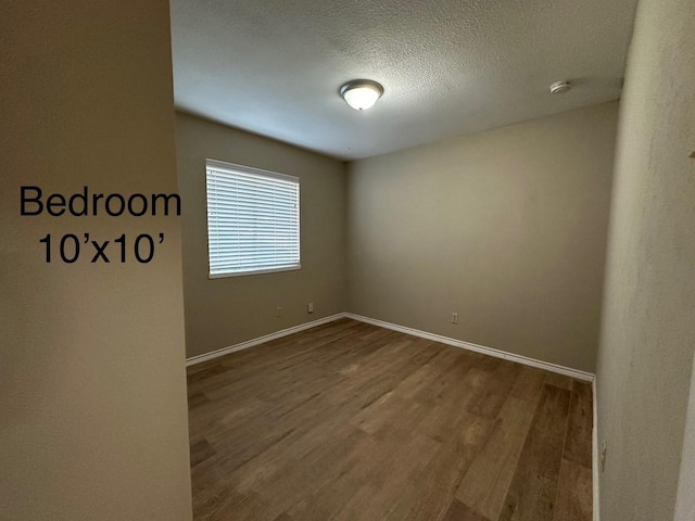 2612 Lemmontree Ln, Plano, TX 75074 - spare room with wood finished floors, a smoke detector, a textured ceiling, and baseboards