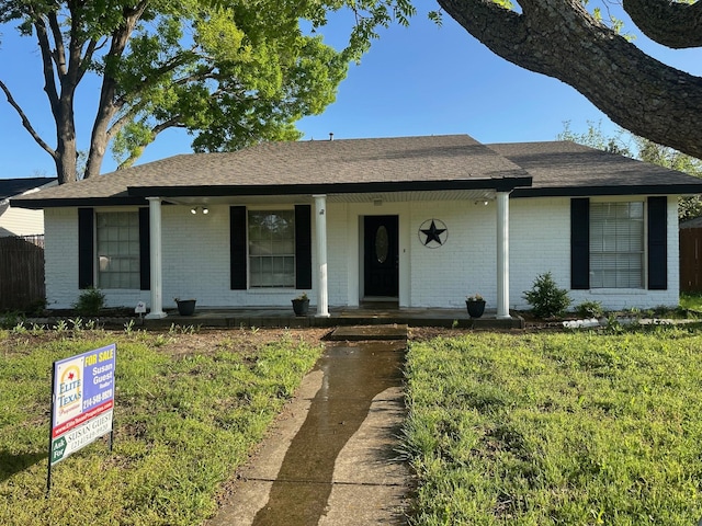 2612 Lemmontree Ln, Plano, TX 75074 - ranch-style house featuring brick siding, roof with shingles, a porch, and a front lawn