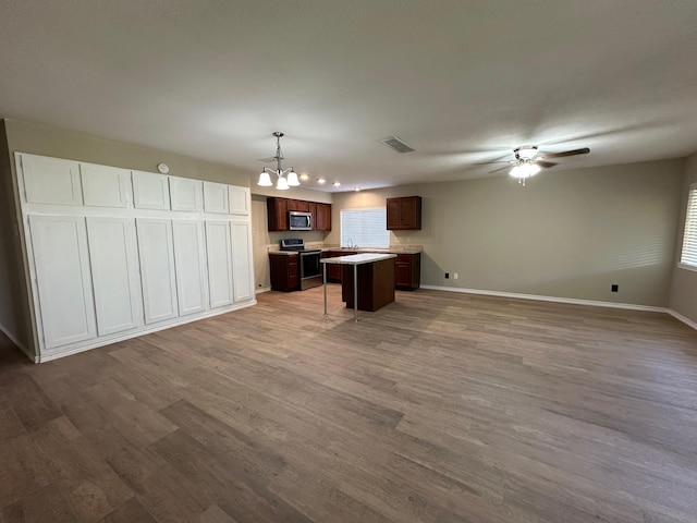 2612 Lemmontree Ln, Plano, TX 75074 - kitchen with stainless steel appliances, open floor plan, light countertops, and wood finished floors