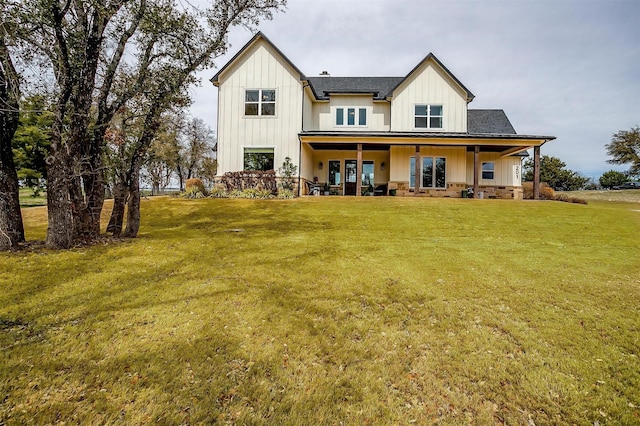201 Flat Rock Ln, Weatherford, TX 76088 - rear view of house featuring board and batten siding, a yard, and covered porch