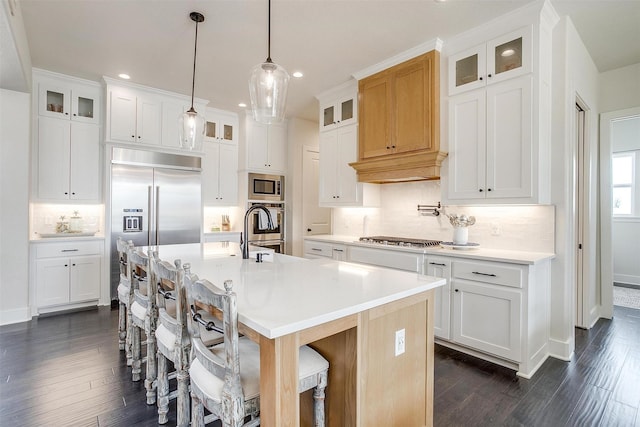 201 Flat Rock Ln, Weatherford, TX 76088 - kitchen featuring built in appliances, decorative backsplash, recessed lighting, dark wood-style flooring, and a center island with sink