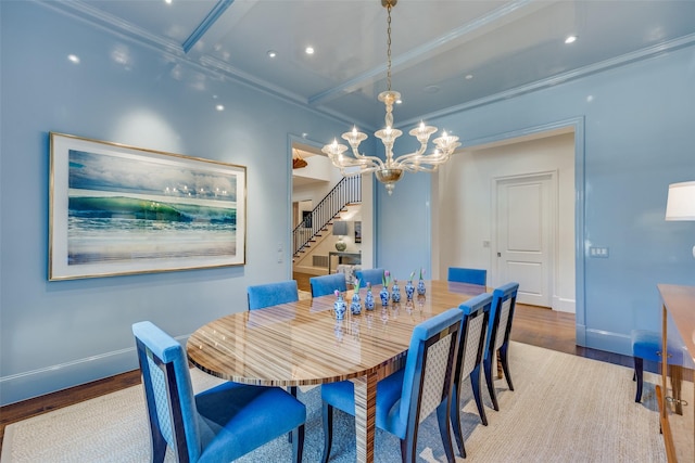 dining area featuring a notable chandelier, stairway, baseboards, and wood finished floors