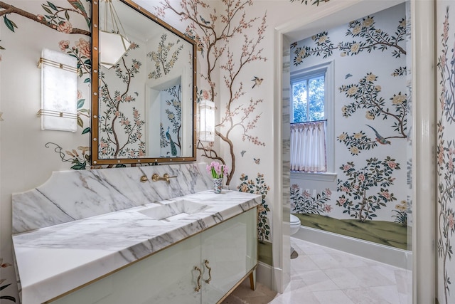 bathroom featuring vanity, toilet, tile patterned flooring, and wallpapered walls