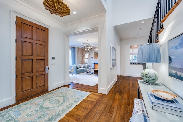 entrance foyer with crown molding, hardwood / wood-style flooring, plenty of natural light, and baseboards