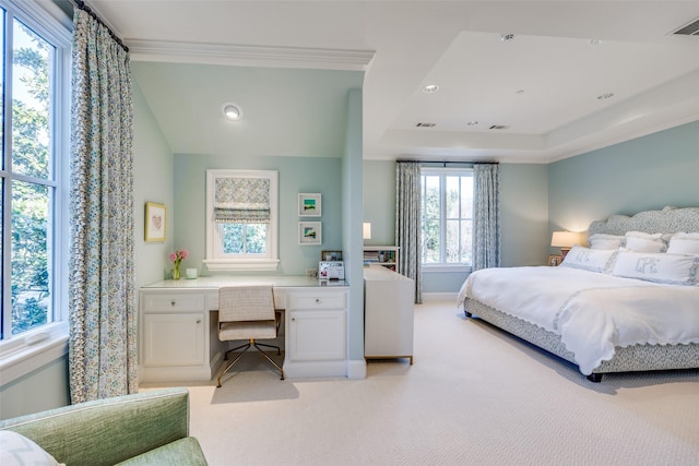 bedroom featuring visible vents, light colored carpet, built in study area, and crown molding