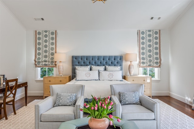 bedroom featuring visible vents, multiple windows, and wood finished floors