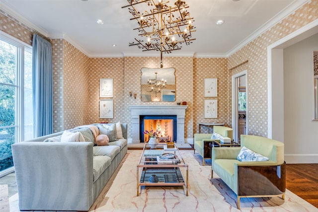 living area featuring an inviting chandelier, crown molding, and wallpapered walls