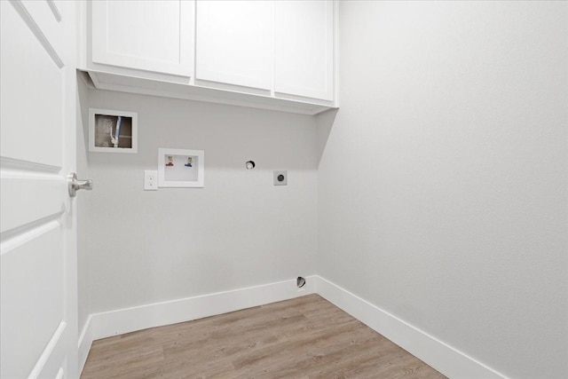 washroom with electric dryer hookup, light wood-type flooring, cabinet space, and baseboards