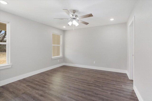 empty room with dark wood finished floors, recessed lighting, a ceiling fan, and baseboards