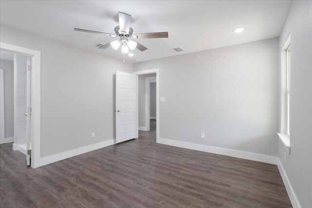 unfurnished bedroom featuring visible vents, baseboards, dark wood-style floors, and a ceiling fan
