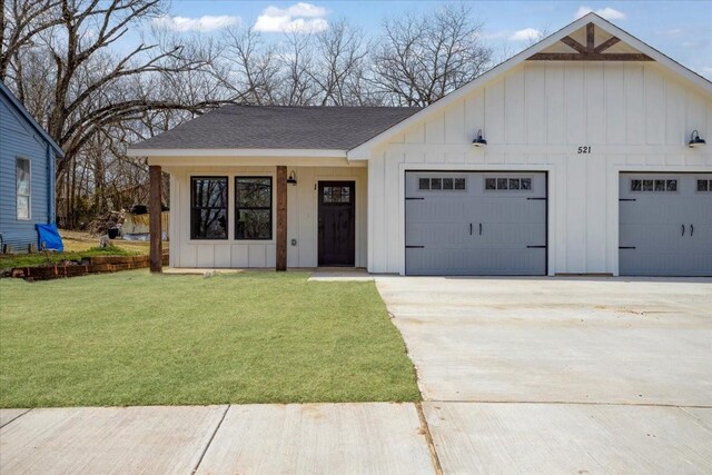 modern farmhouse style home featuring driveway, roof with shingles, board and batten siding, a front yard, and a garage