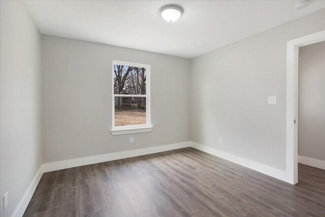 empty room featuring baseboards and wood finished floors