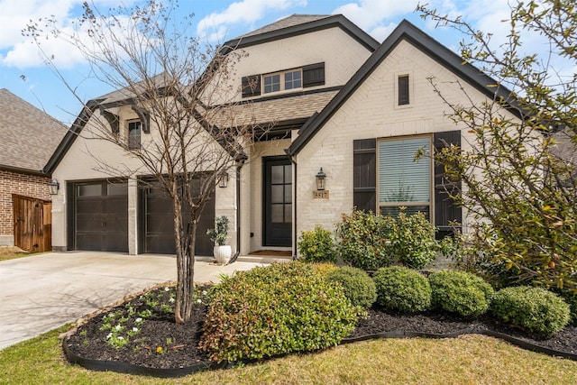 view of front of property with a shingled roof and driveway