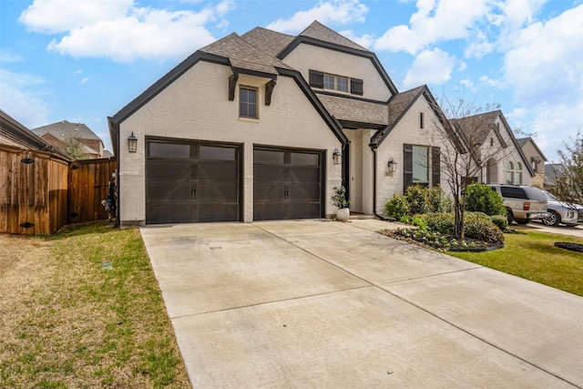 french country inspired facade featuring a front yard, brick siding, a shingled roof, and fence