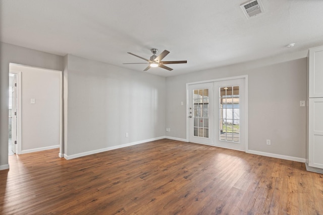 unfurnished room with visible vents, baseboards, a ceiling fan, and wood finished floors