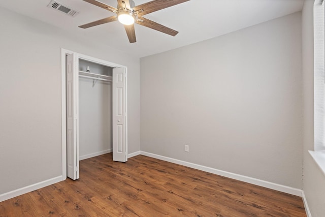 unfurnished bedroom with visible vents, baseboards, and wood finished floors