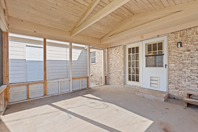 unfurnished sunroom with vaulted ceiling with beams and wood ceiling