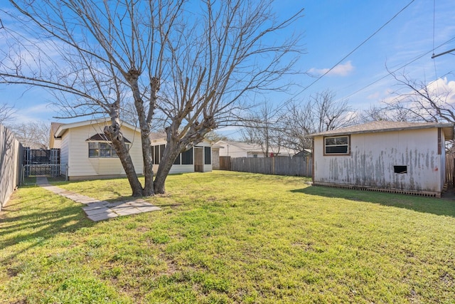 view of yard featuring an outdoor structure and a fenced backyard