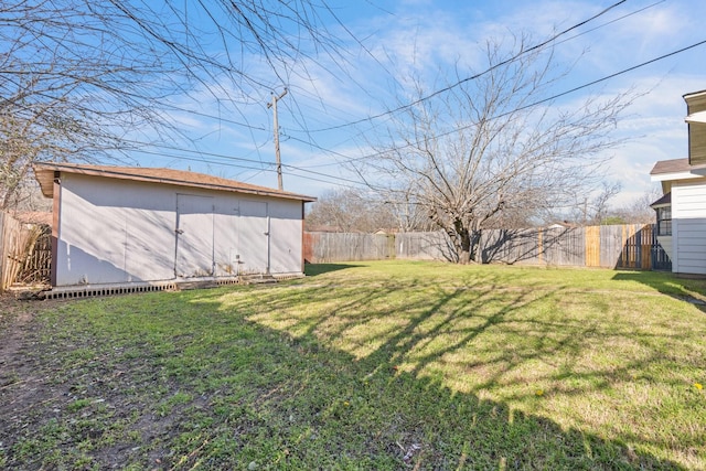 view of yard featuring a storage unit, an outdoor structure, and a fenced backyard