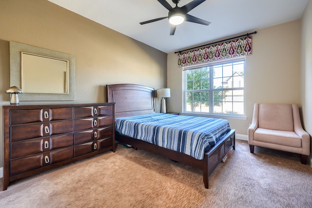 carpeted bedroom featuring baseboards and a ceiling fan
