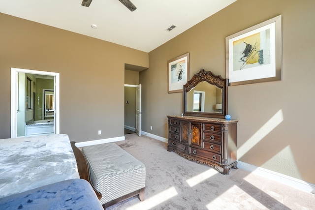 carpeted bedroom with connected bathroom, baseboards, visible vents, and ceiling fan