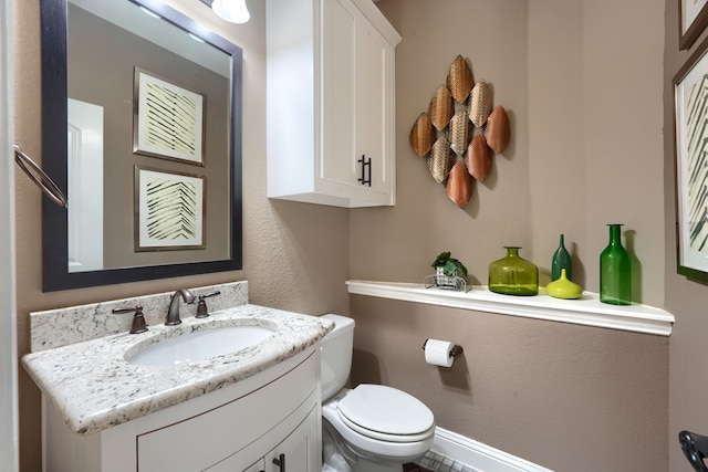 half bathroom with toilet and vanity