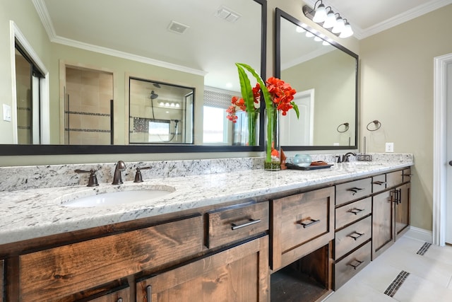 bathroom featuring double vanity, a sink, crown molding, and visible vents