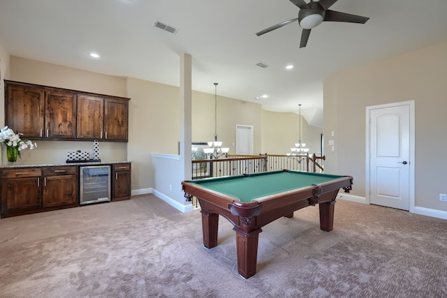 rec room with light colored carpet, baseboards, bar, wine cooler, and visible vents