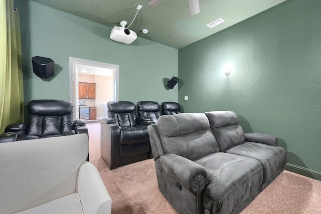 carpeted cinema featuring a textured wall and visible vents