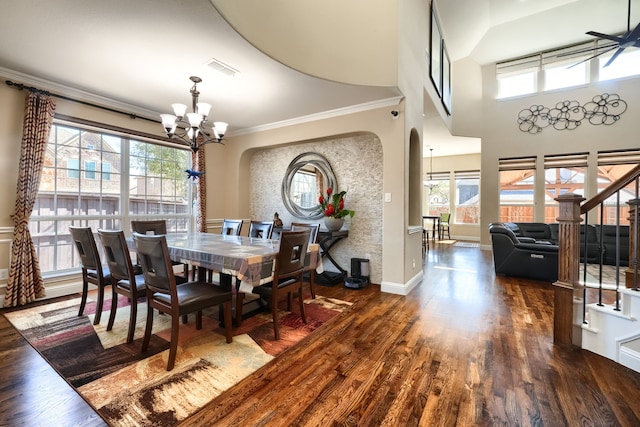 dining space with stairs, ornamental molding, a chandelier, arched walkways, and wood finished floors