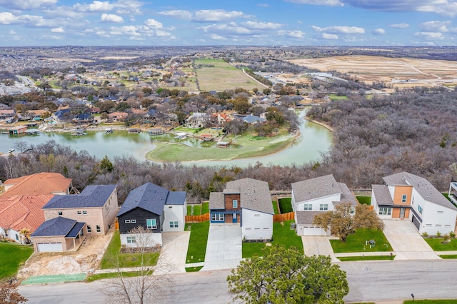 drone / aerial view with a residential view and a water view